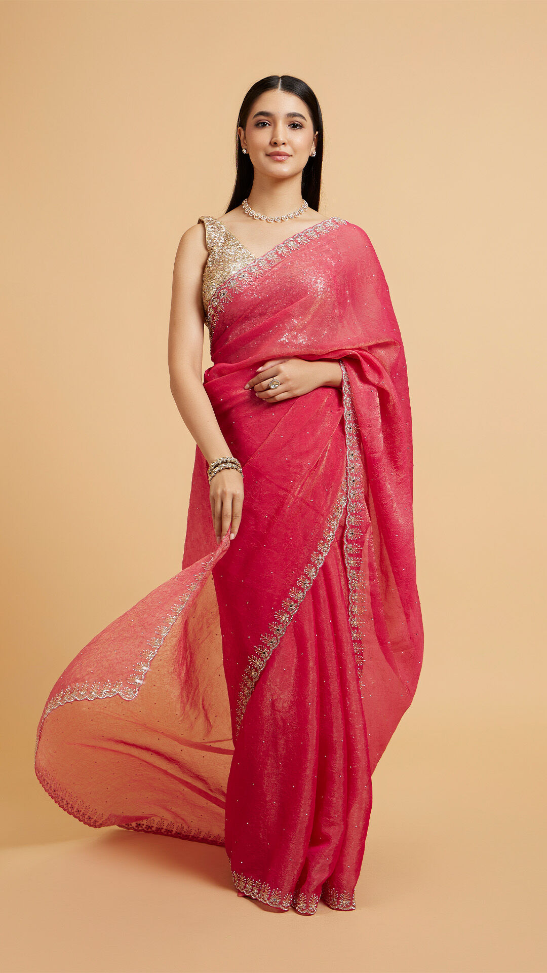 A lady posing in a red saree